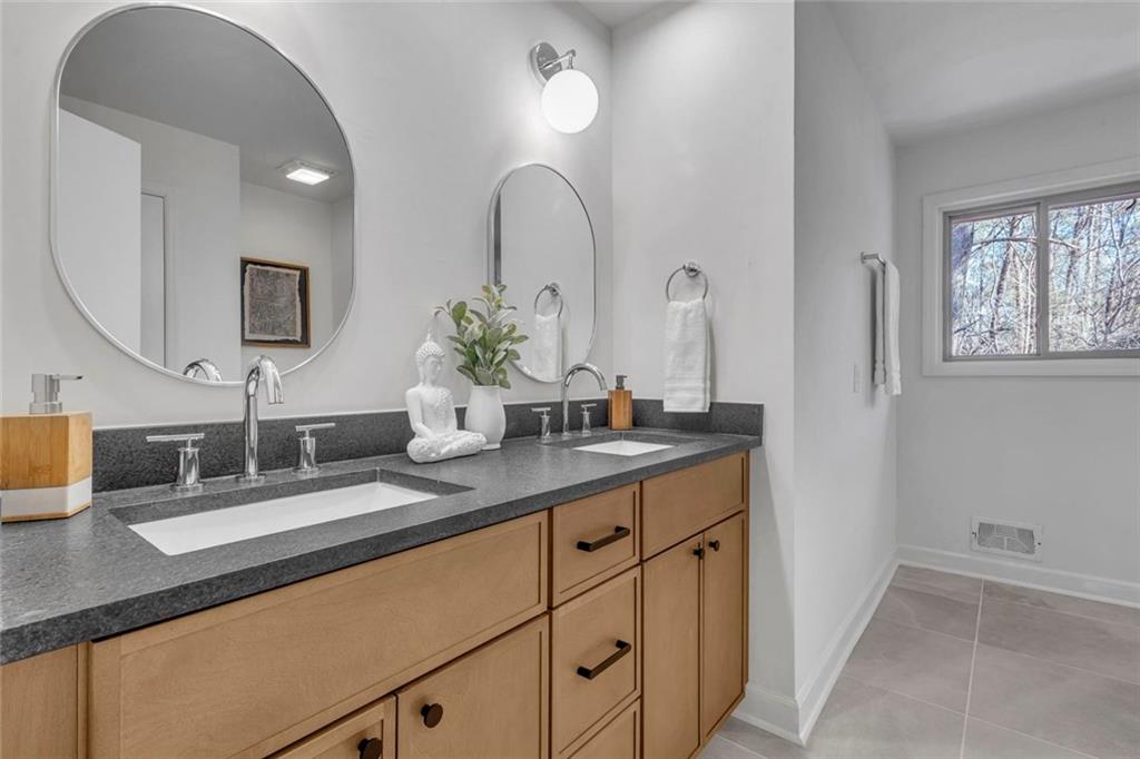 260 Devilla Trace Fayetteville, GA 30214 - Photo 29 of 47 a bathroom with double vanity sinks a vanity a lamp and a mirror