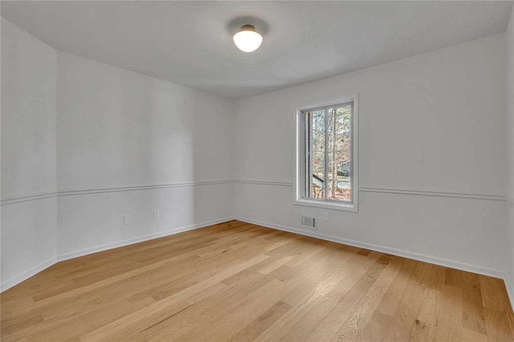 260 Devilla Trace Fayetteville, GA 30214 - Photo 35 of 47 wooden floor in an empty room with a window