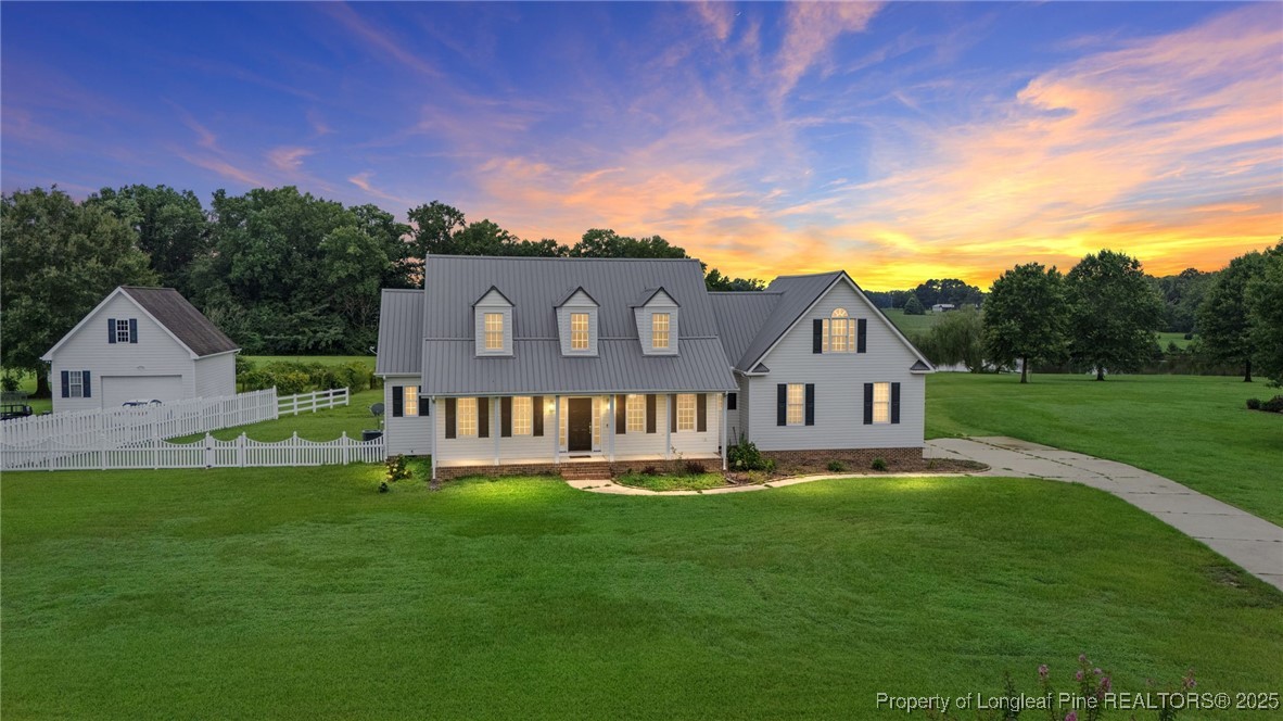 5247 Old Stage Road North Angier, NC 27501 - Photo 1 of 42 a front view of a house with a garden and yard