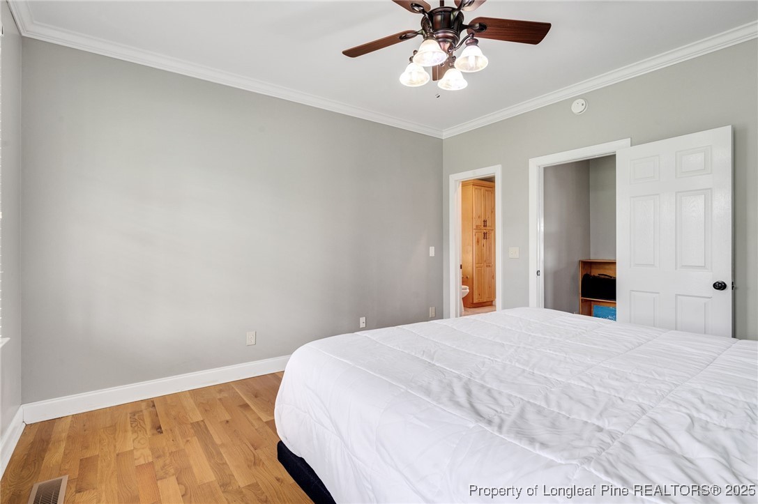 5247 Old Stage Road North Angier, NC 27501 - Photo 17 of 42 a bedroom with a large bed and a chandelier