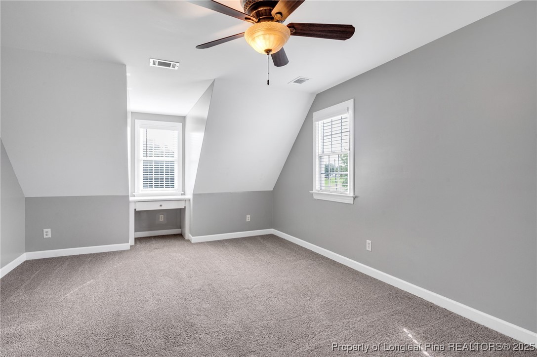 5247 Old Stage Road North Angier, NC 27501 - Photo 21 of 42 an empty room with windows and fan