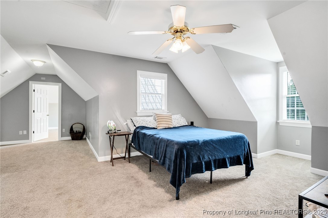5247 Old Stage Road North Angier, NC 27501 - Photo 24 of 42 a bedroom with a bed and a chandelier
