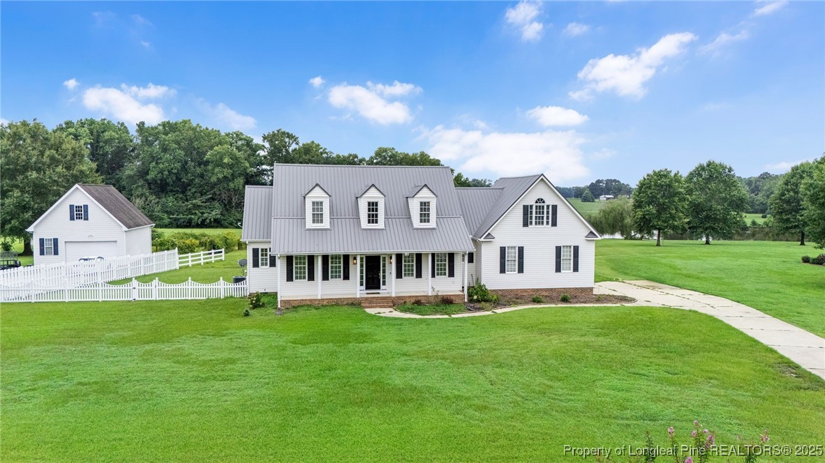 5247 Old Stage Road North Angier, NC 27501 - Photo 3 of 42 a front view of a house with a garden and yard