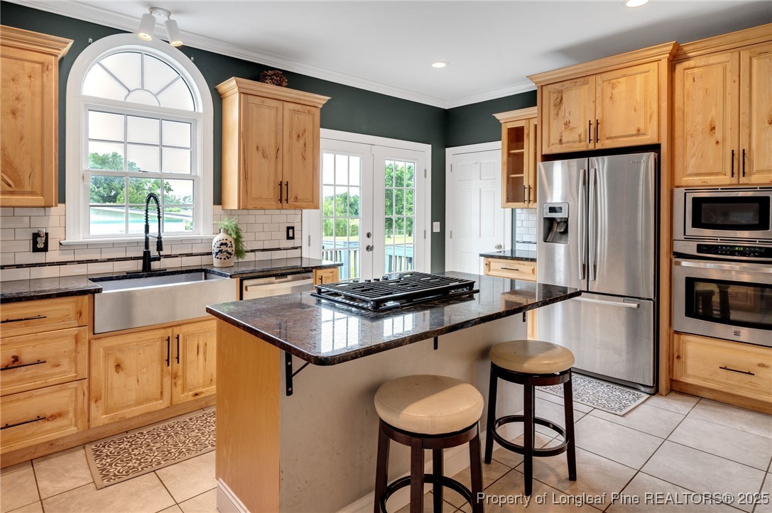 5247 Old Stage Road North Angier, NC 27501 - Photo 10 of 42 a kitchen with stainless steel appliances a sink a stove a refrigerator cabinets and dining table