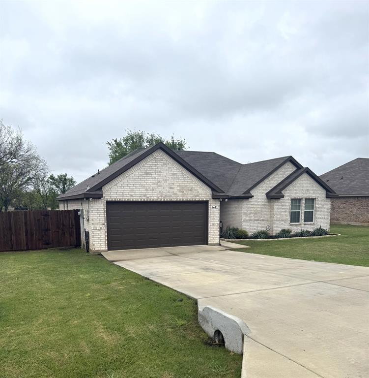 641 Half Moon Way Runaway Bay, TX 76426 - Photo 1 of 1 a front view of house with yard and garage