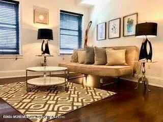 a living room with furniture and a lamp