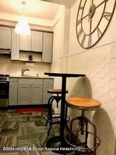 a view of a kitchen with kitchen island a table and chairs in it