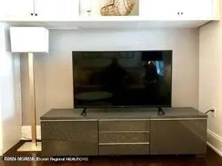 a living room with a fireplace and a flat screen tv