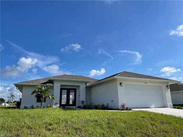 a front view of a house with a yard