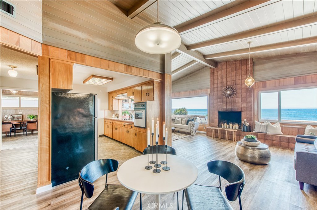 8 Ocean Front Lane, Unit AB Cayucos, CA 93430 - Photo 14 of 36 a view of a dining room with furniture wooden floor and chandelier