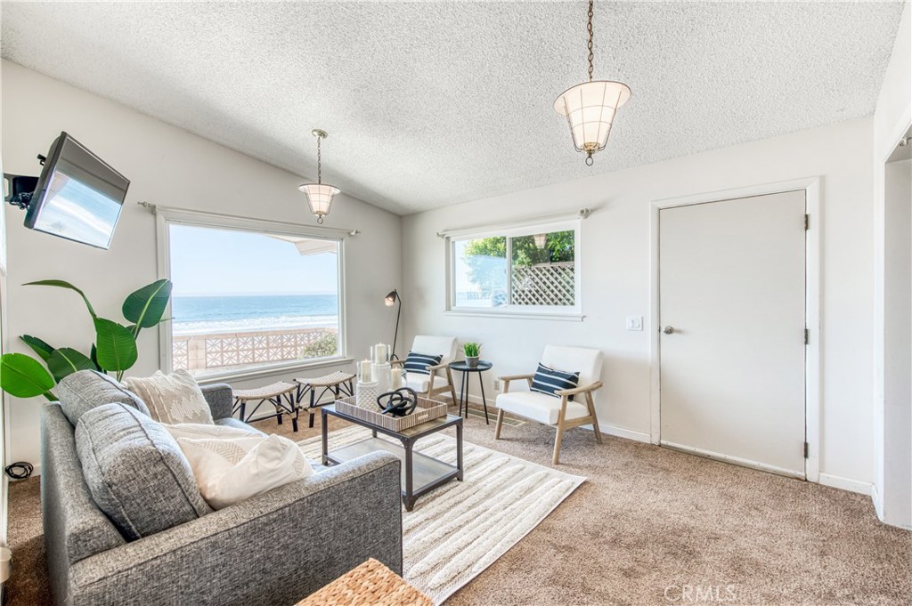 8 Ocean Front Lane, Unit AB Cayucos, CA 93430 - Photo 18 of 36 a living room with furniture and wooden floor