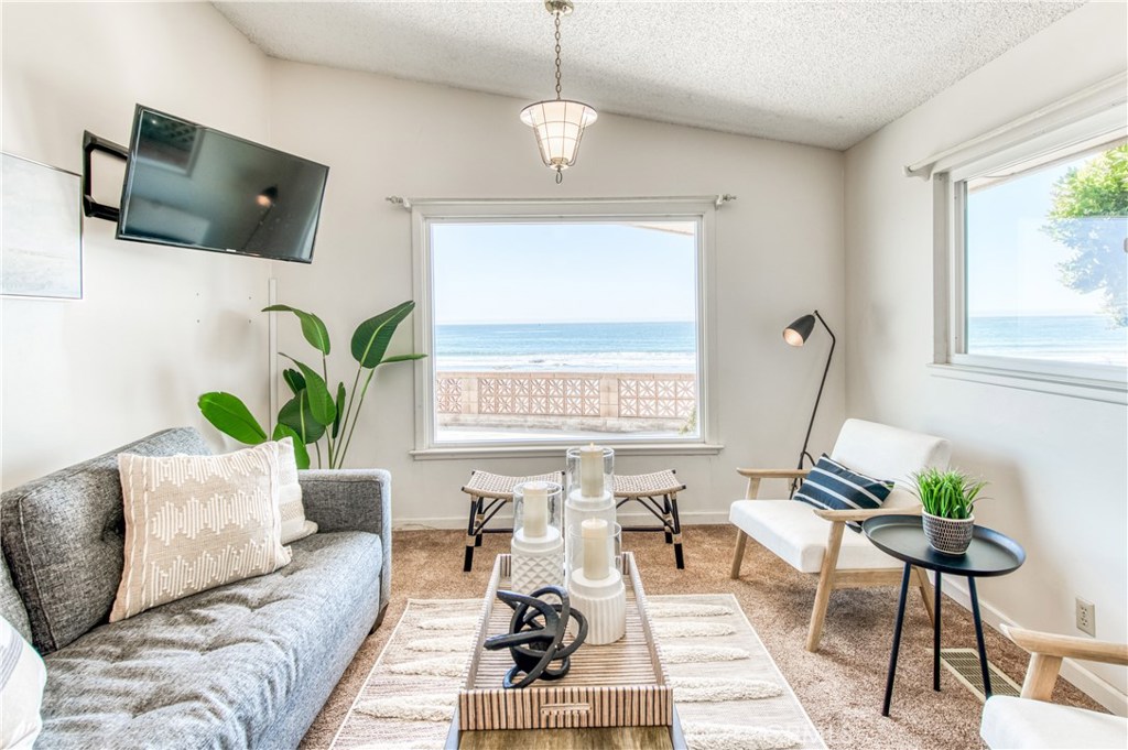8 Ocean Front Lane, Unit AB Cayucos, CA 93430 - Photo 19 of 36 a living room with furniture a flat screen tv and a window