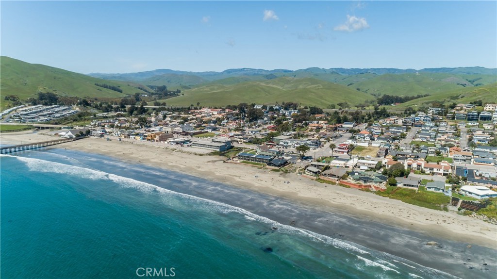 8 Ocean Front Lane, Unit AB Cayucos, CA 93430 - Photo 33 of 36 a view of a town with mountains in the background