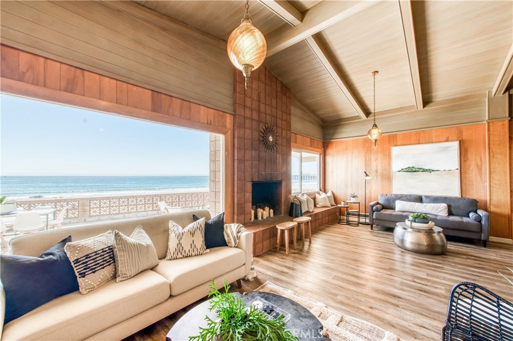 8 Ocean Front Lane, Unit AB Cayucos, CA 93430 - Photo 10 of 36 a living room with furniture chandelier and a large window