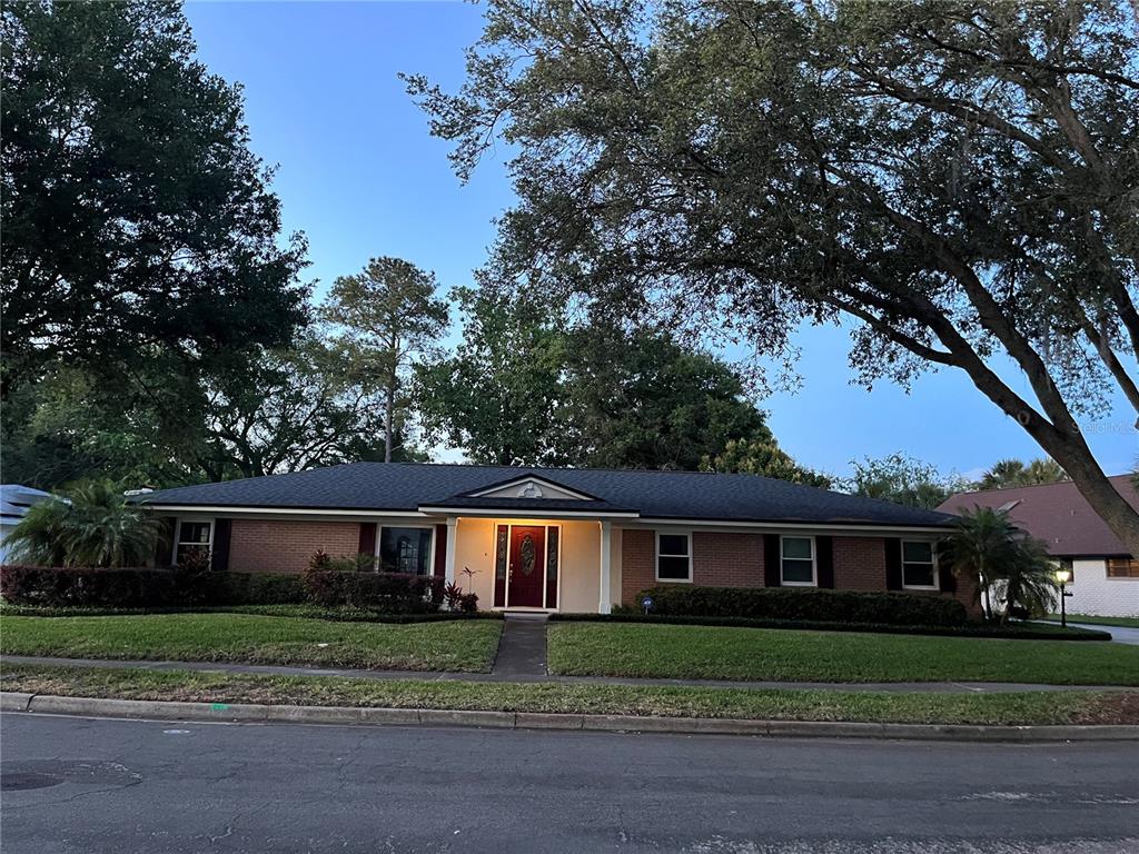 a front view of a house with a yard and a garage