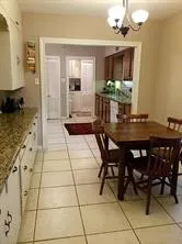 a large kitchen with granite countertop a sink and a stove