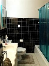 2103 Swift Boulevard Houston, TX 77030 - Photo 18 of 23 a bathroom with a toilet a sink and mirror