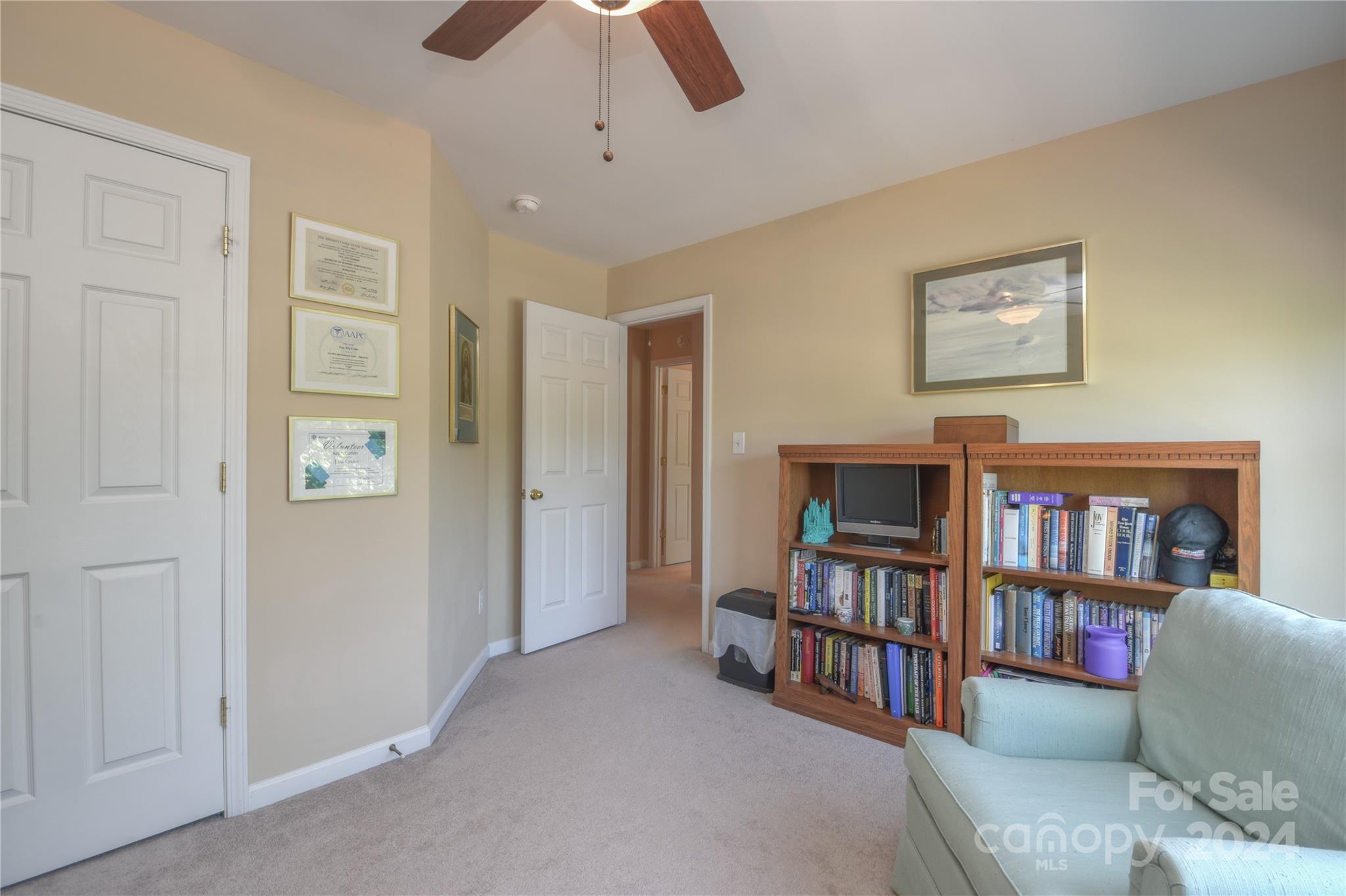1472 Haverford Road Northwest Concord, NC 28027 - Photo 13 of 30 a living room with furniture and a book shelf