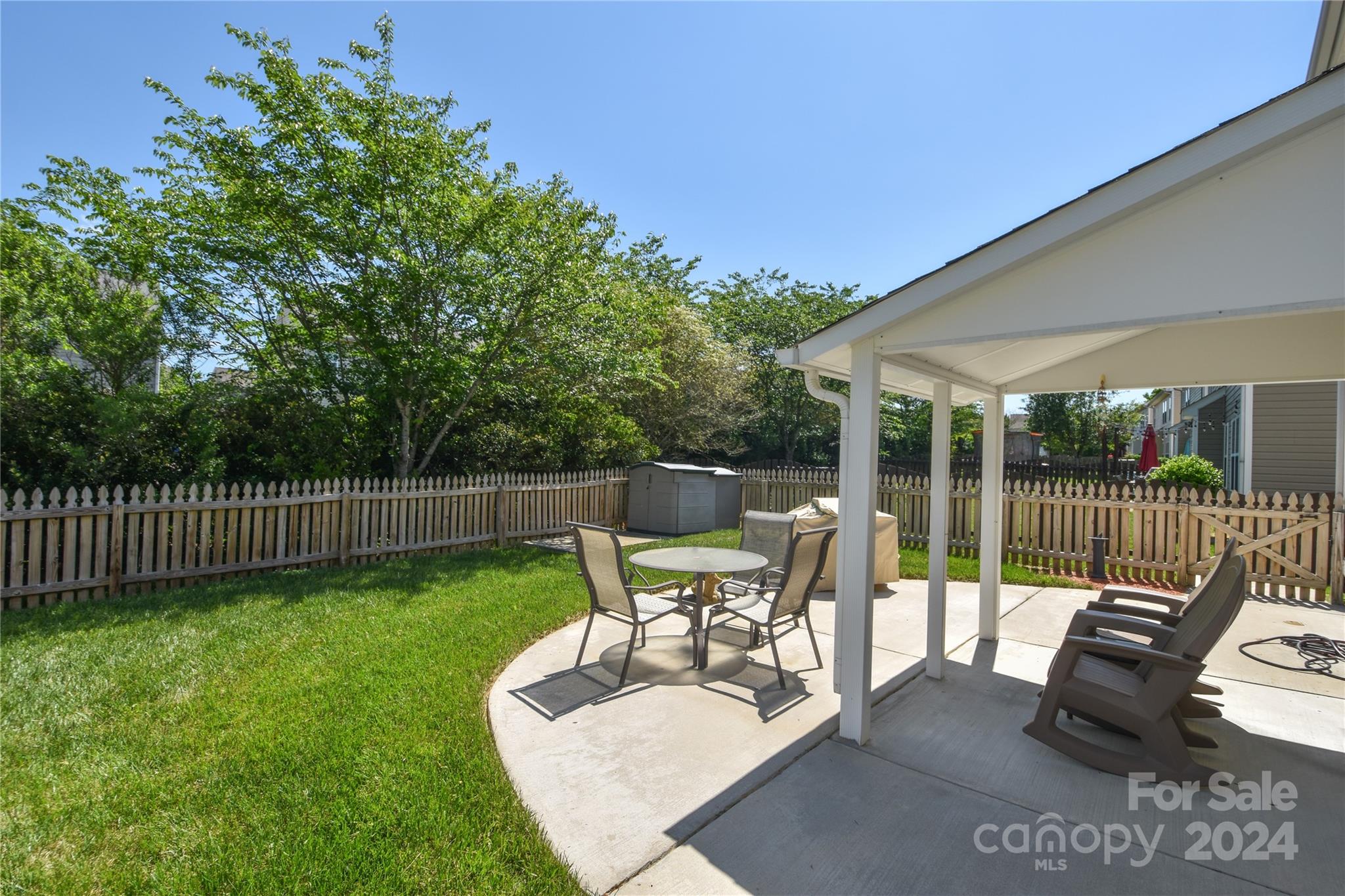 1472 Haverford Road Northwest Concord, NC 28027 - Photo 18 of 30 a view of a patio with a table chairs and a garden