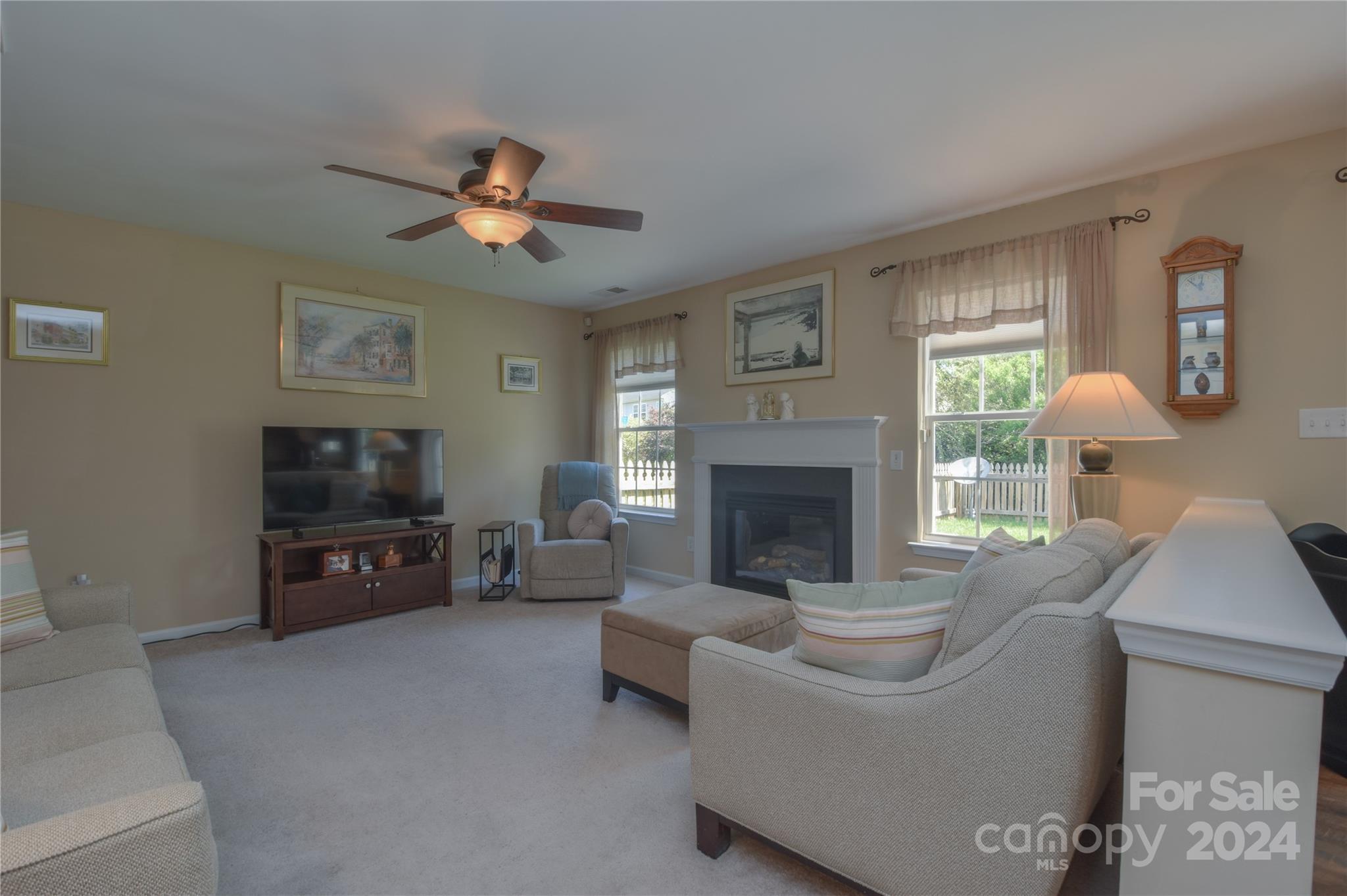 1472 Haverford Road Northwest Concord, NC 28027 - Photo 3 of 30 a living room with furniture a flat screen tv and a fireplace