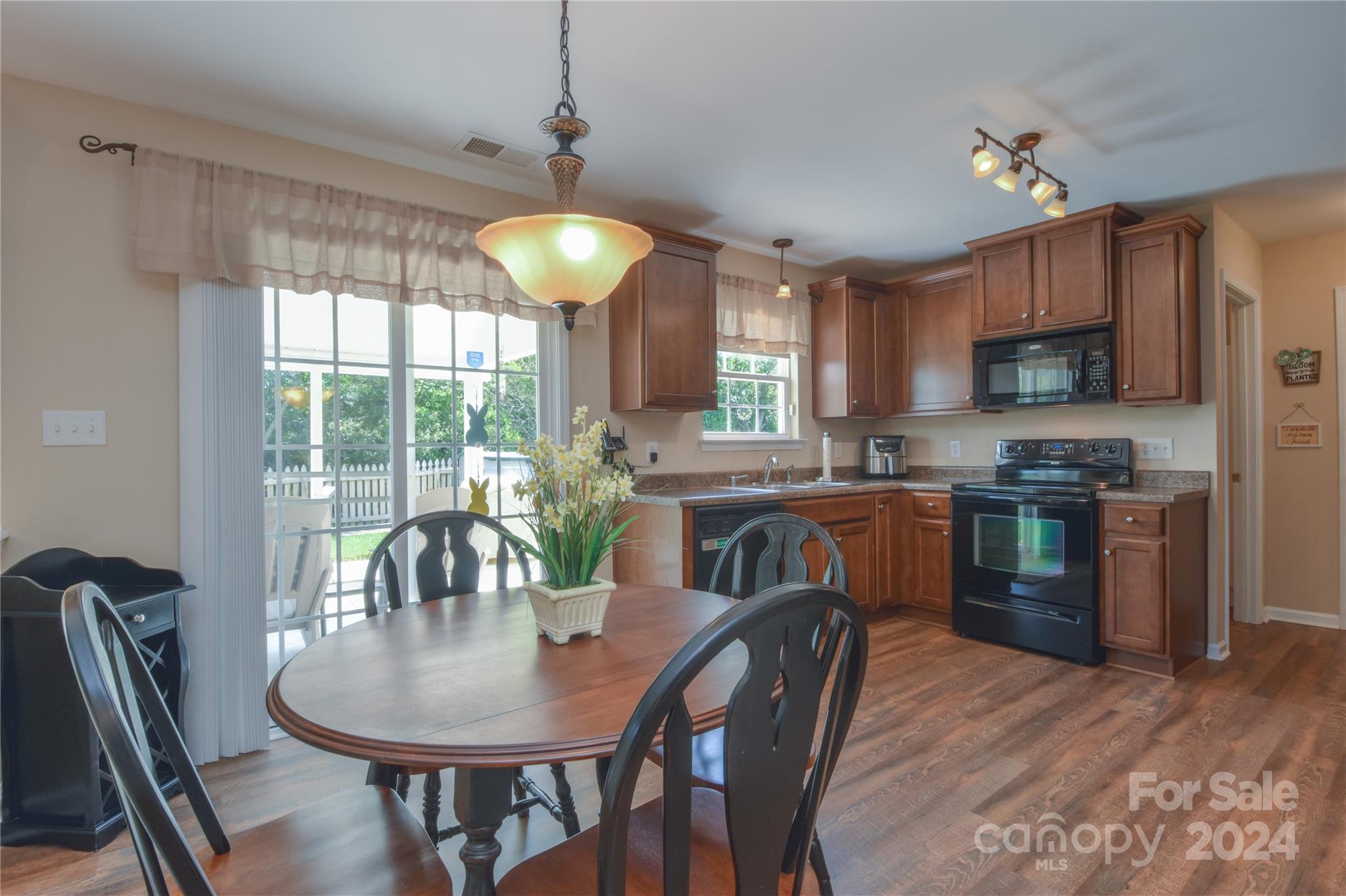 1472 Haverford Road Northwest Concord, NC 28027 - Photo 4 of 30 a kitchen with a dining table chairs stainless steel appliances and cabinets