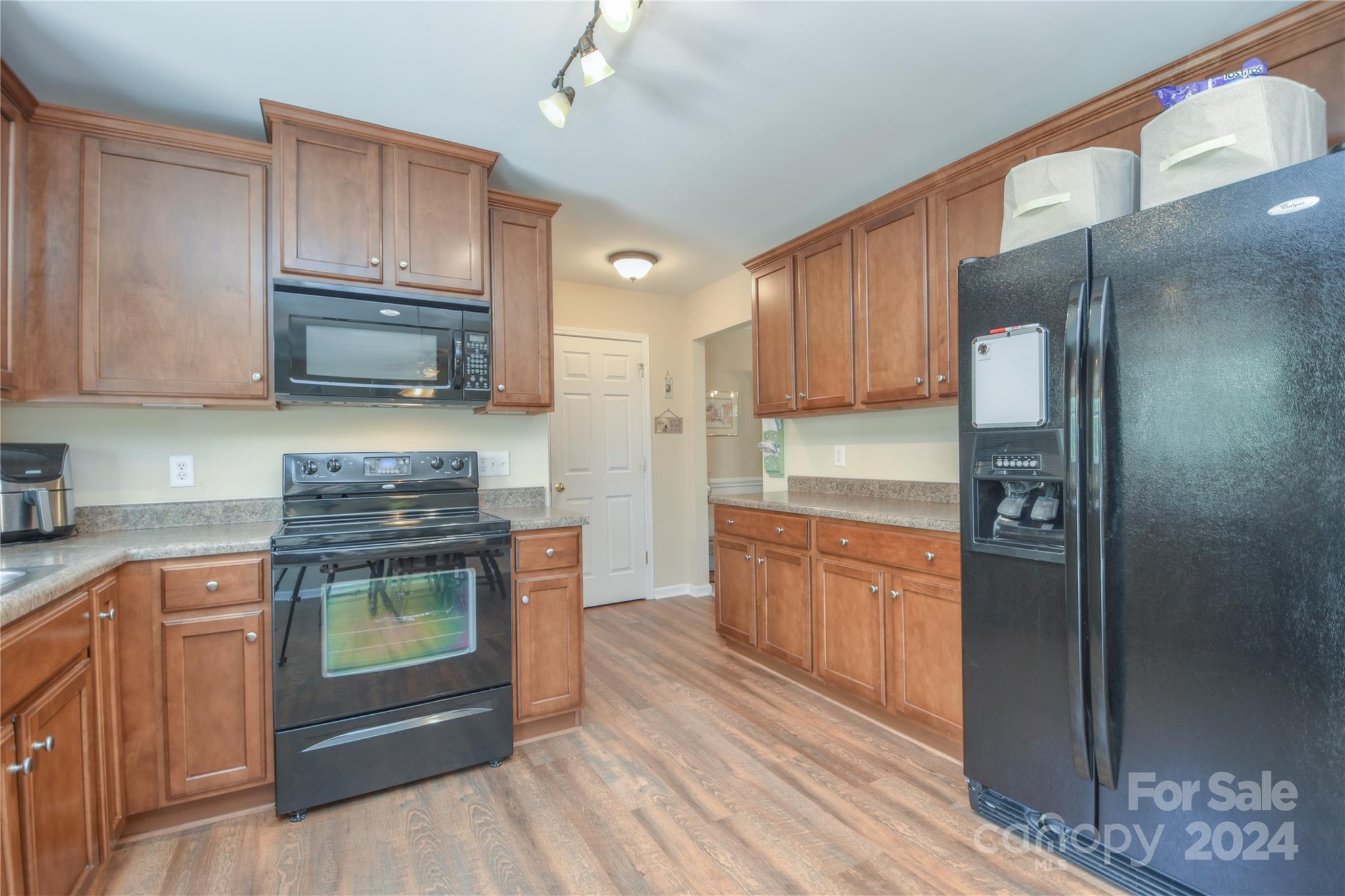 1472 Haverford Road Northwest Concord, NC 28027 - Photo 5 of 30 a kitchen with granite countertop a refrigerator stove and sink