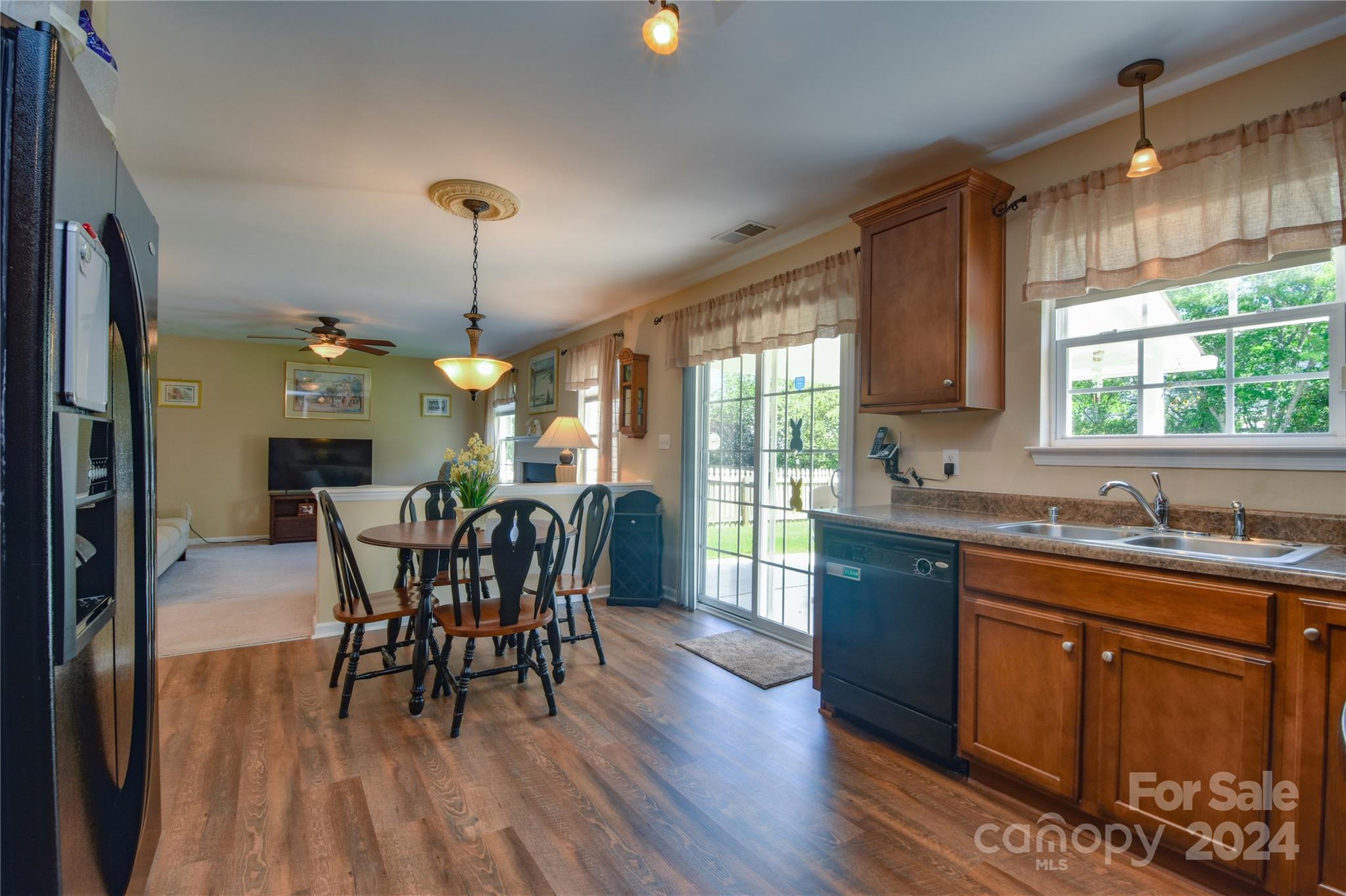1472 Haverford Road Northwest Concord, NC 28027 - Photo 6 of 30 a dining room with furniture a chandelier and wooden floor