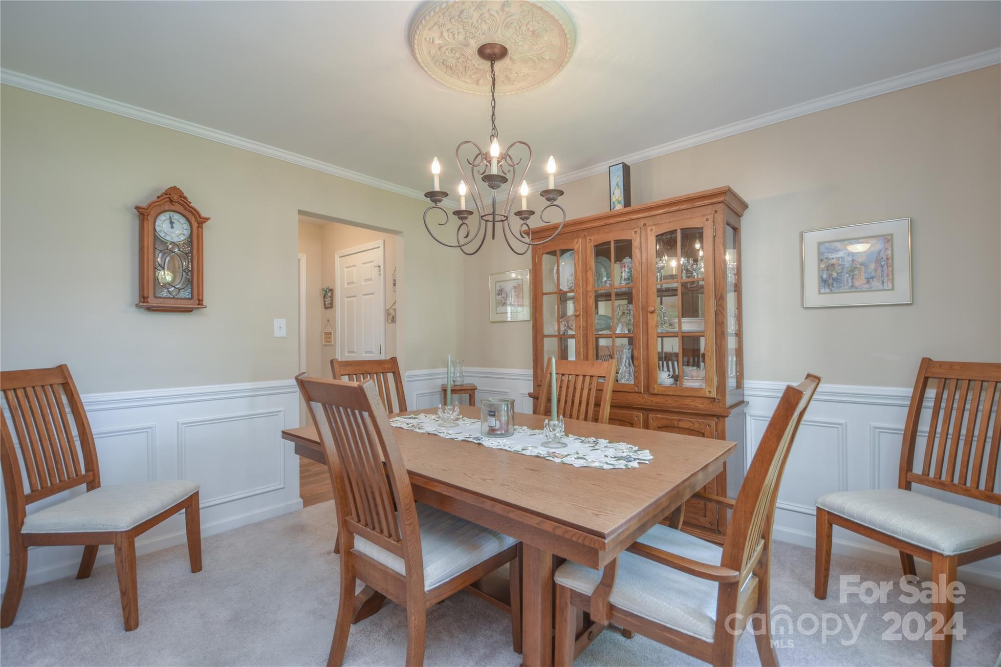 1472 Haverford Road Northwest Concord, NC 28027 - Photo 7 of 30 a view of a dining room with furniture a chandelier and wooden floor