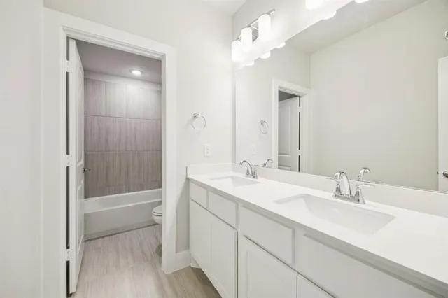 a bathroom with a sink a tub and a mirror