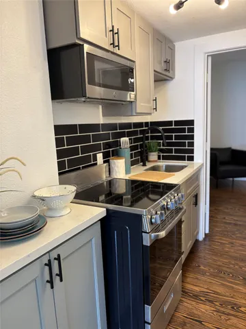 a kitchen with a stove and a microwave