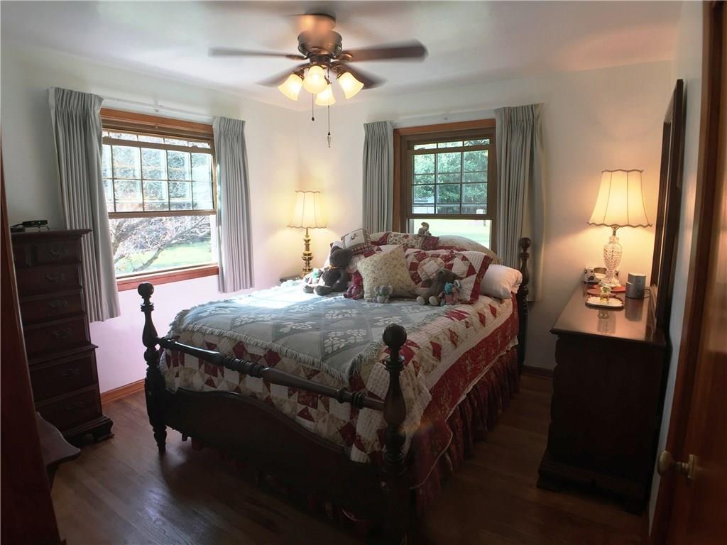 149 Township Line Road Butler, PA 16002 - Photo 14 of 25 Quiet master bedroom featuring two nice windows, hardwood flooring and ceiling fan with light 13 x 11