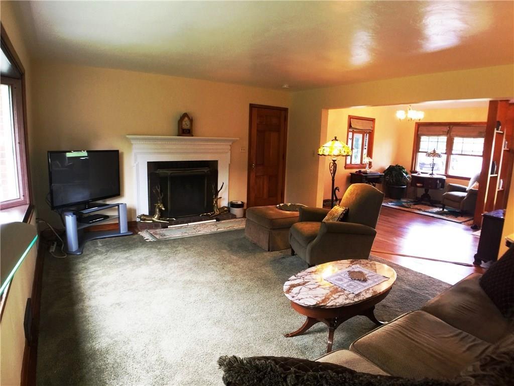 149 Township Line Road Butler, PA 16002 - Photo 5 of 25 Sizeable living room complete with a wood burning fireplace, hardwood flooring and a gorgeous bay window to admire your view