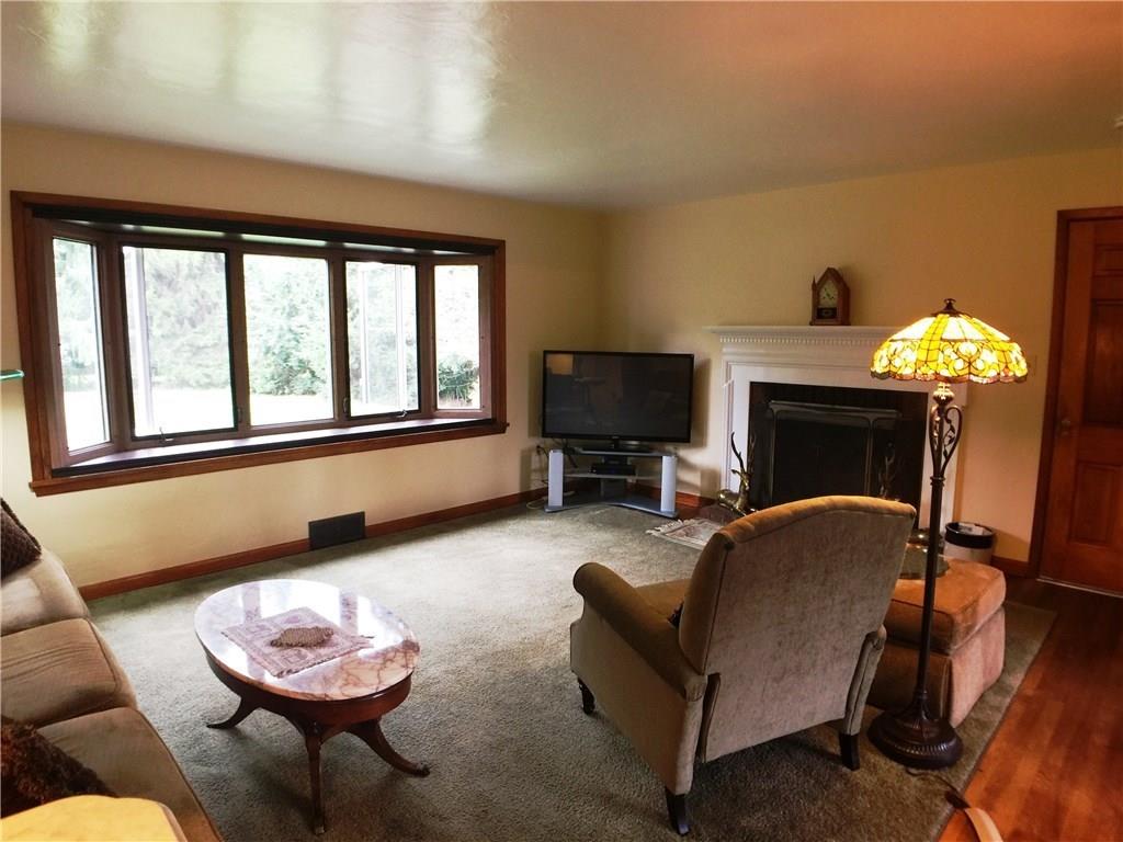149 Township Line Road Butler, PA 16002 - Photo 9 of 25 Spacious living room with hardwood flooring, wood burning fireplace