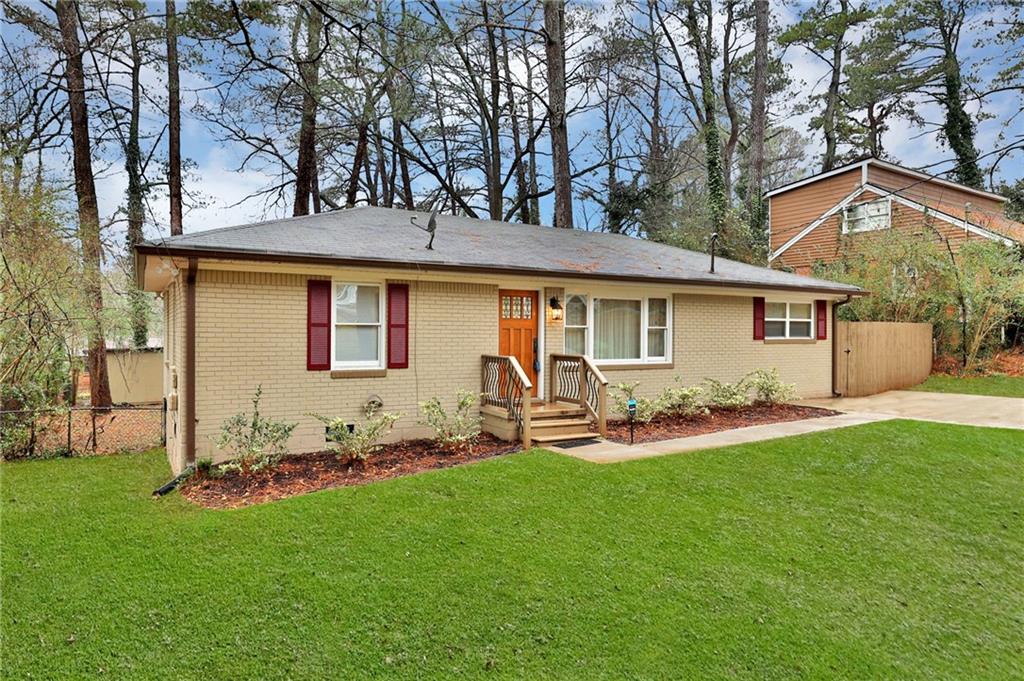 1909 Pinedale Place Decatur, GA 30032 - Photo 1 of 1 a front view of a house with a garden and yard