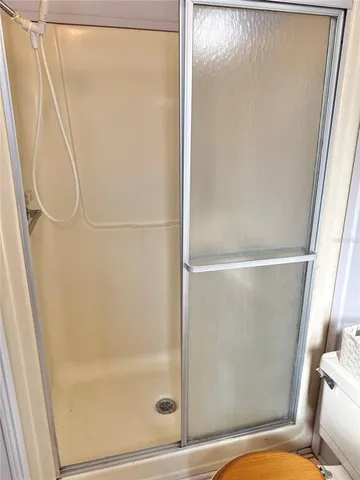 a bathroom with a glass shower door