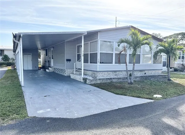 a view of a house with a yard and a garage