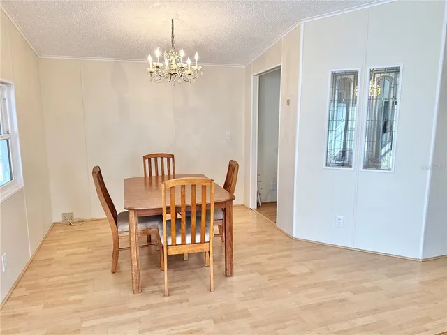 a view of a dining room with furniture and chandelier
