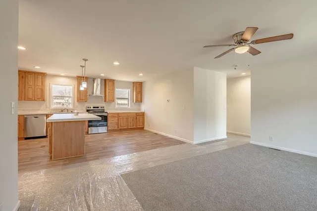 a view of a kitchen with a sink and a refrigerator