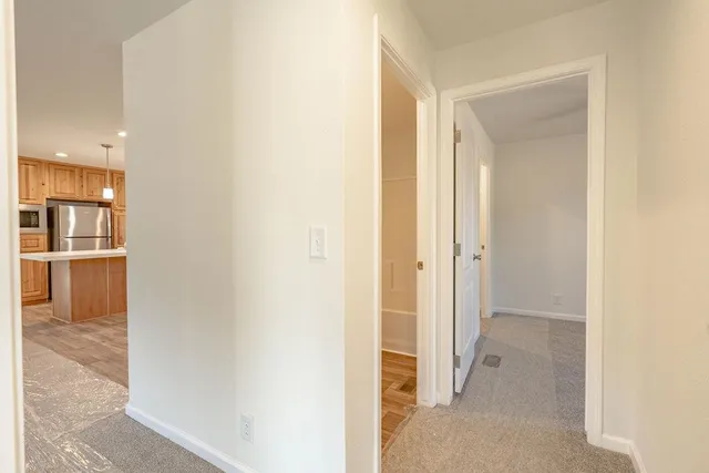 a view of a hallway with wooden shelves