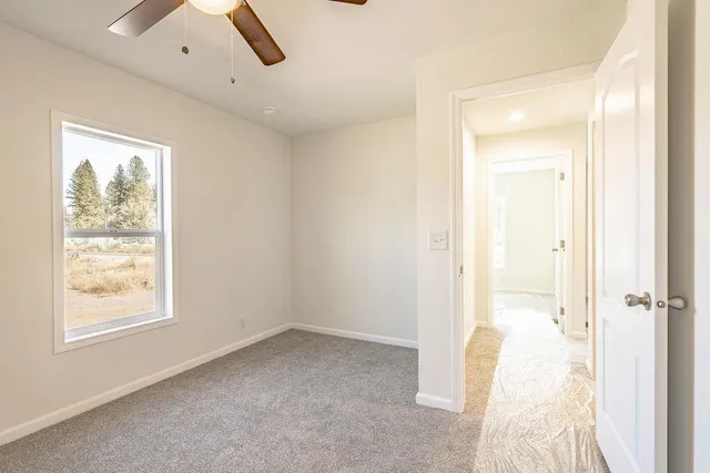an empty room with a bathroom and a shower