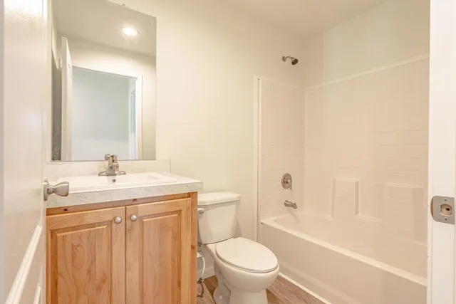a bathroom with a double vanity sink toilet and shower
