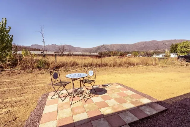 a view of a room with a table and chairs