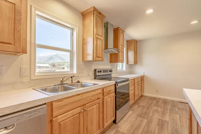 a kitchen with a sink a window and cabinets