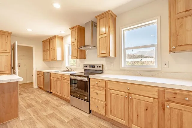a kitchen with cabinets a sink and appliances