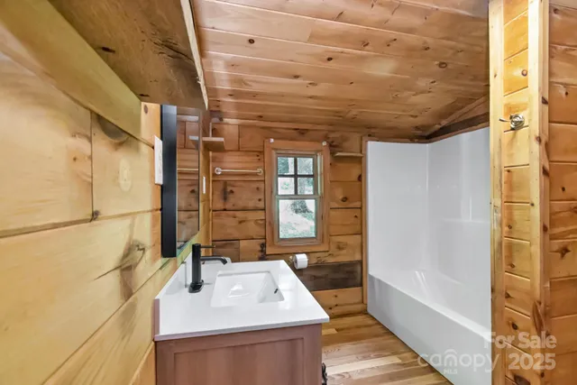 a bathroom with a sink a bathtub and shower