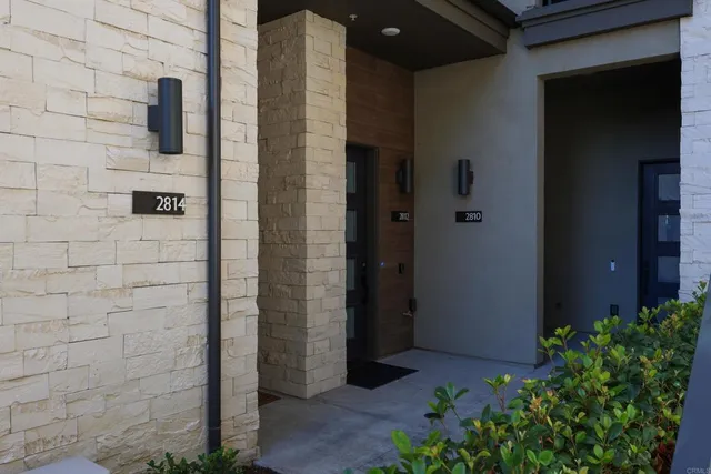 a brick building with a potted plant on the door