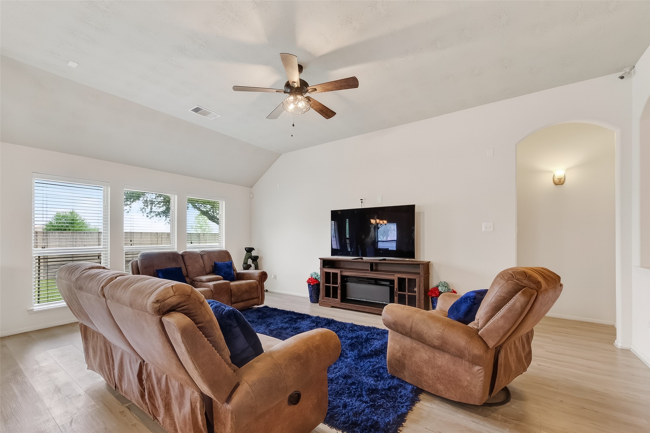 13415 Star Creek Lane Rosharon, TX 77583 - Photo 13 of 46 a living room with furniture a fireplace and a flat screen tv