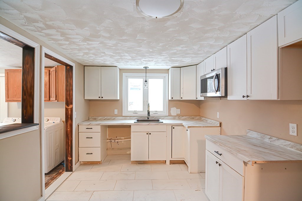 519 S Road Templeton, MA 01468 - Photo 5 of 30 a kitchen with a stove top oven sink and cabinets