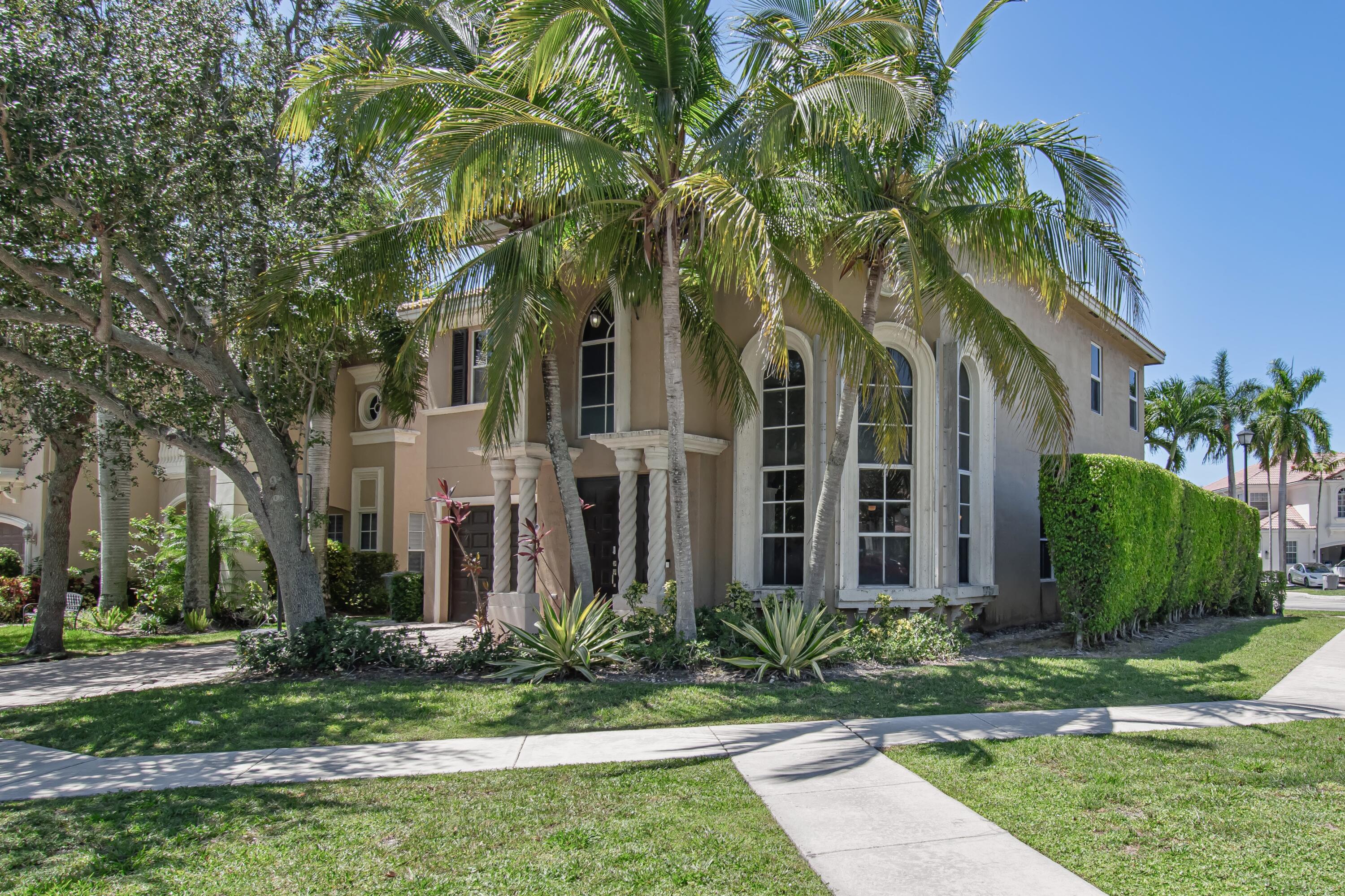 9851 Palma Vista Way Boca Raton, FL 33428 - Photo 1 of 33 front view of a house with a garden