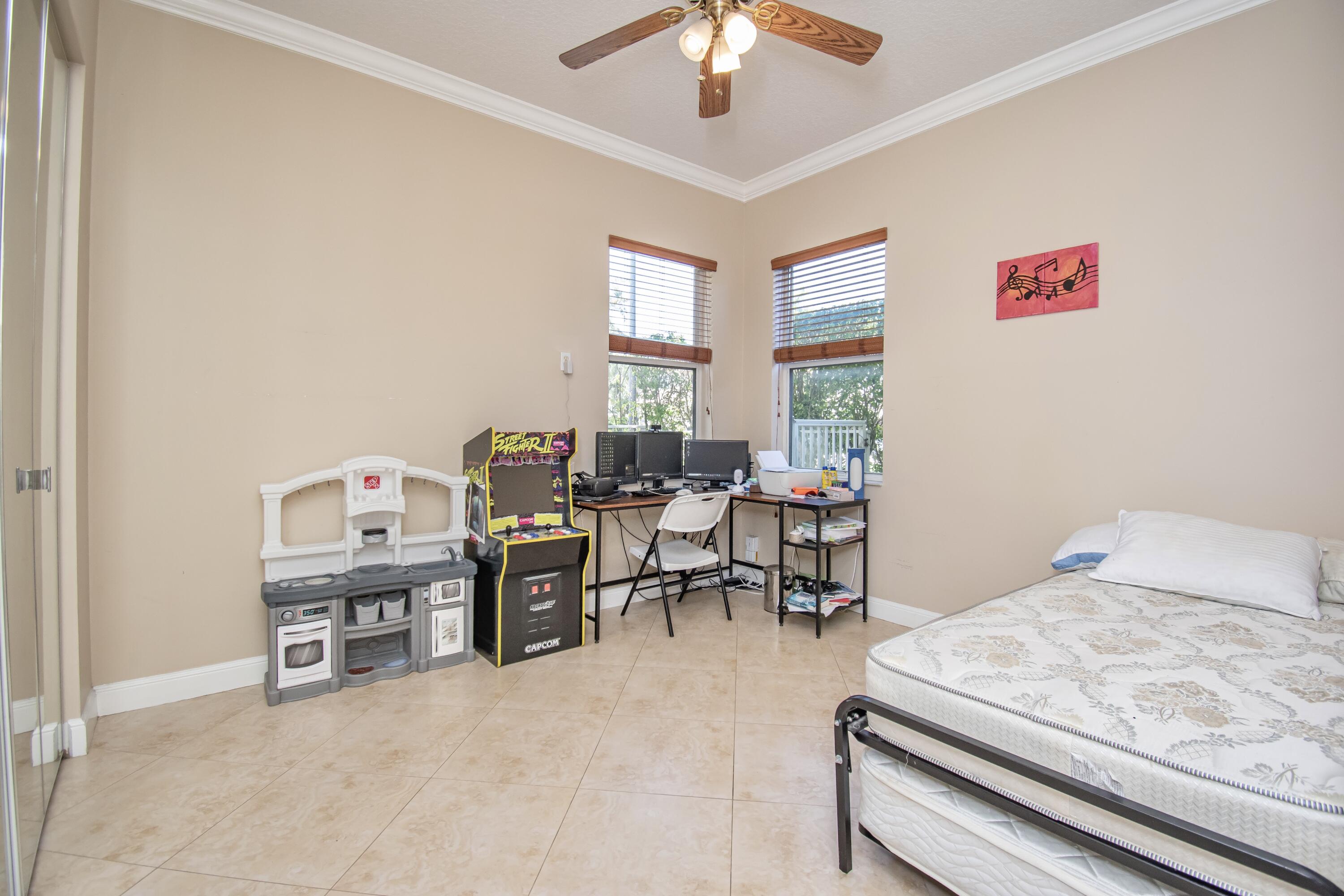 9851 Palma Vista Way Boca Raton, FL 33428 - Photo 24 of 33 a living room with furniture and a chandelier